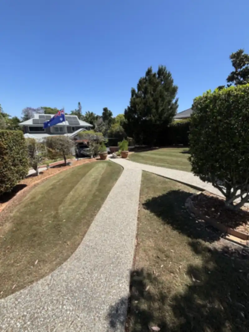Neatly mown lawn and driveway edge at a Moreton Bay home ready for a lawn mowing quote