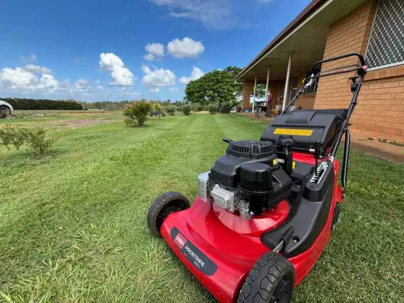 Push mower on a freshly cut front lawn in North Lakes illustrating lawn mowing cost in Moreton Bay